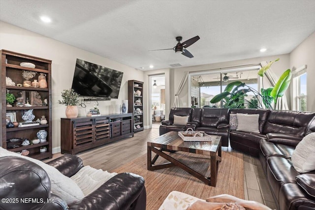 living area featuring visible vents, wood finished floors, recessed lighting, and ceiling fan
