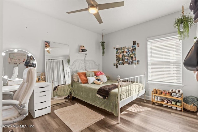 bedroom with ceiling fan and wood finished floors