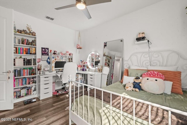 bedroom featuring wood finished floors and visible vents