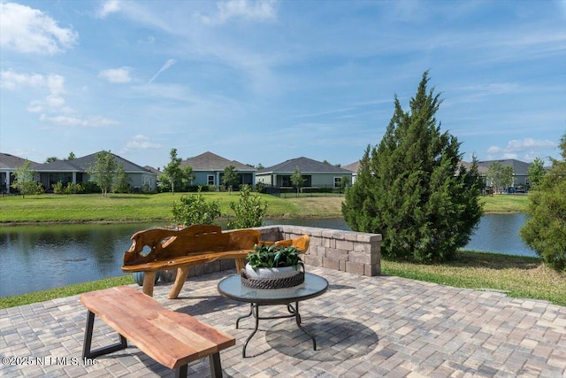 view of patio / terrace featuring a residential view and a water view