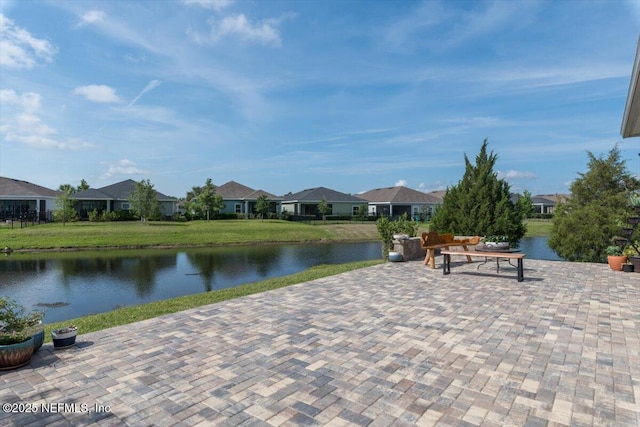 view of patio / terrace with a water view and a residential view