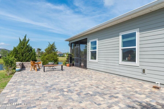 view of patio featuring a sunroom