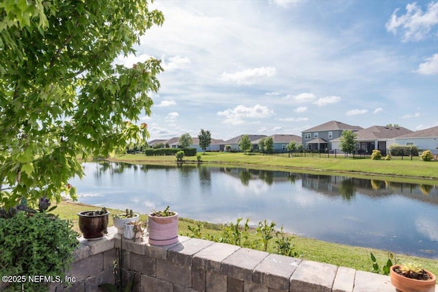 property view of water with fence and a residential view