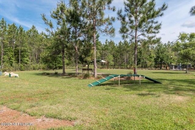surrounding community featuring fence and a lawn