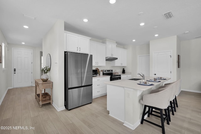 143 Bayard Pl, Jacksonville, FL 32259 - kitchen featuring appliances with stainless steel finishes, a sink, an island with sink, under cabinet range hood, and visible vents