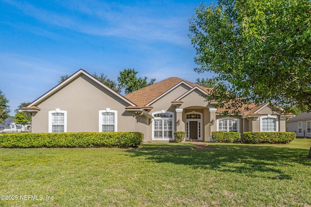 view of front of property with a front lawn and stucco siding