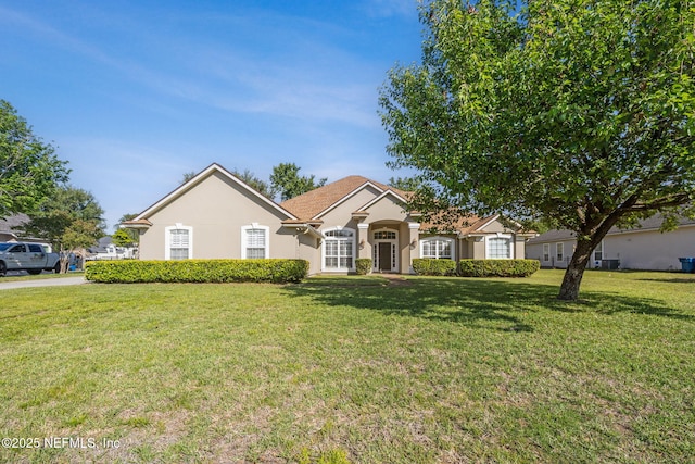 single story home with a front yard and stucco siding
