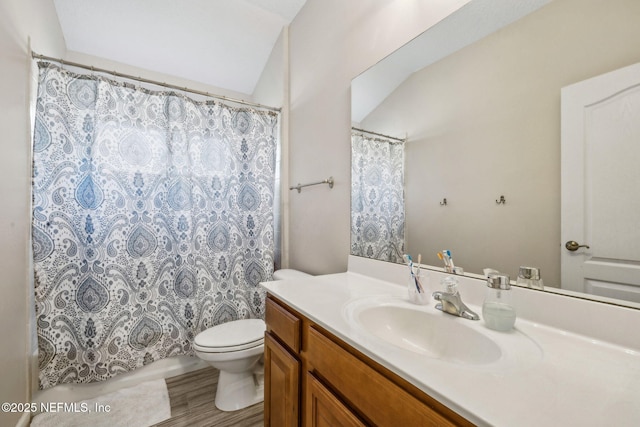 bathroom with lofted ceiling, wood finished floors, toilet, vanity, and a shower with shower curtain