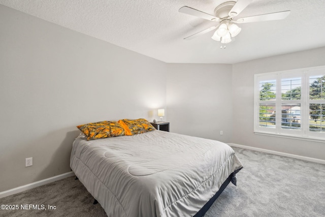 bedroom featuring carpet, a textured ceiling, a ceiling fan, and baseboards