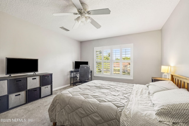 bedroom featuring a ceiling fan, a textured ceiling, light carpet, baseboards, and visible vents