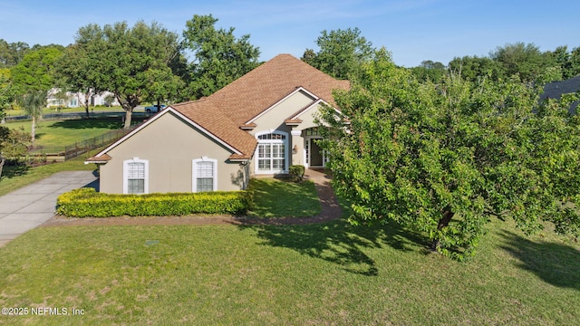 view of front of property with a front lawn and stucco siding