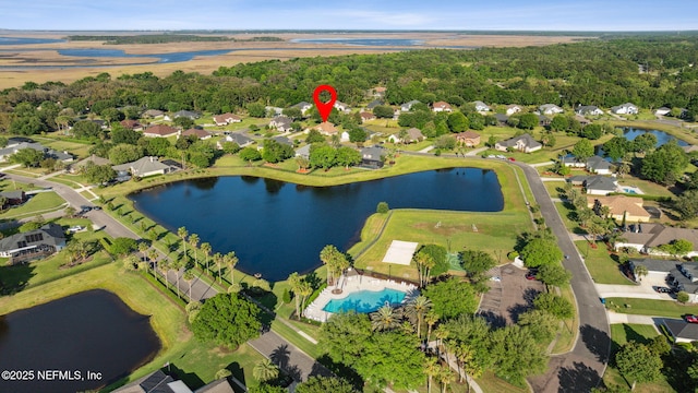drone / aerial view featuring a residential view and a water view