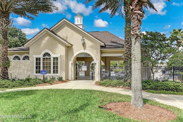 view of front of property with a gate, fence, a shingled roof, stucco siding, and a front yard