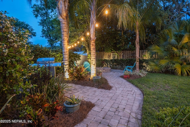 view of yard featuring fence and a patio