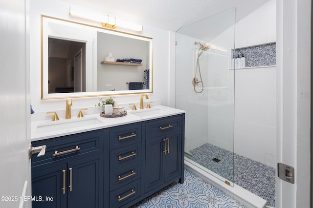 bathroom featuring a tile shower, a sink, and double vanity