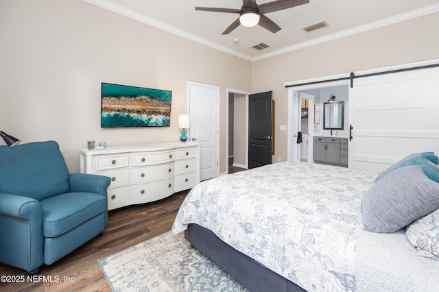bedroom with dark wood-type flooring, visible vents, crown molding, and a barn door