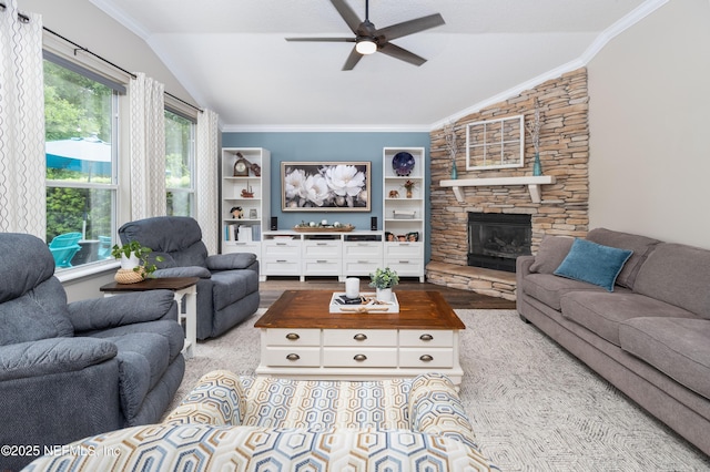 living room with ceiling fan, vaulted ceiling, wood finished floors, and a fireplace