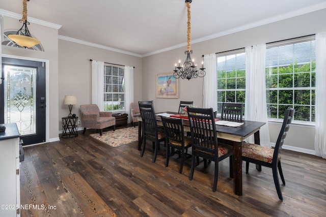 dining room with a notable chandelier, dark wood finished floors, baseboards, and crown molding