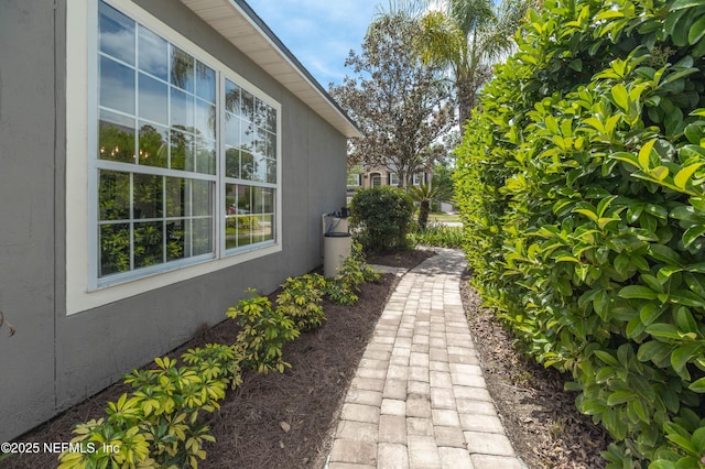 view of side of home with stucco siding