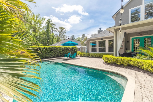 view of swimming pool featuring a patio area and a fenced in pool