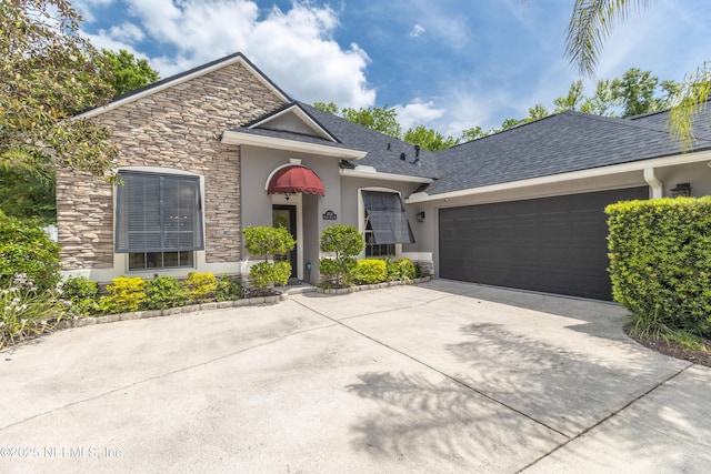 view of front of home featuring stucco siding, driveway, stone siding, and a garage