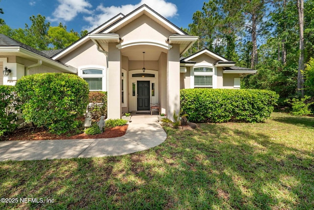 322 Cooper Bay Ct, Saint Augustine, FL 32092 - doorway to property with stucco siding and a yard