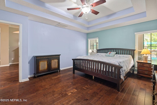 322 Cooper Bay Ct, Saint Augustine, FL 32092 - bedroom featuring visible vents, baseboards, a tray ceiling, and hardwood / wood-style flooring