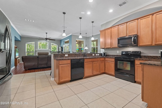 322 Cooper Bay Ct, Saint Augustine, FL 32092 - kitchen featuring visible vents, ornamental molding, a peninsula, a fireplace, and black appliances