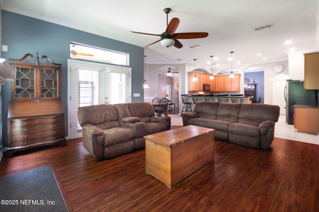 322 Cooper Bay Ct, Saint Augustine, FL 32092 - living room with visible vents, a ceiling fan, arched walkways, and crown molding