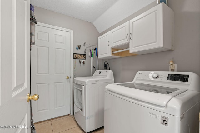 322 Cooper Bay Ct, Saint Augustine, FL 32092 - laundry area with light tile patterned floors, cabinet space, and washer and dryer