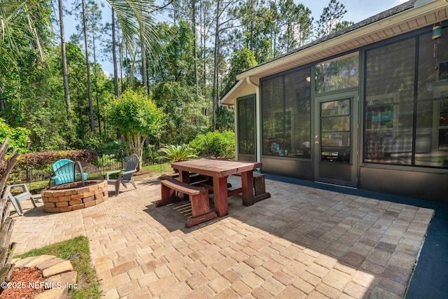 322 Cooper Bay Ct, Saint Augustine, FL 32092 - view of patio / terrace featuring outdoor dining space, a sunroom, and an outdoor fire pit