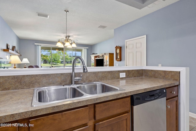 kitchen featuring brown cabinets, a sink, a chandelier, stainless steel dishwasher, and visible vents