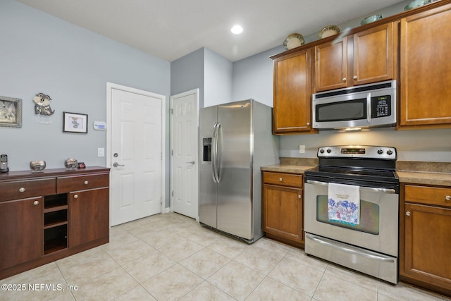 kitchen featuring appliances with stainless steel finishes and brown cabinets