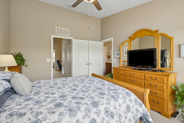 bedroom with carpet floors, ceiling fan, a closet, and visible vents