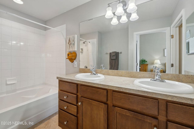 ensuite bathroom featuring double vanity, shower / bath combo, a sink, and tile patterned flooring