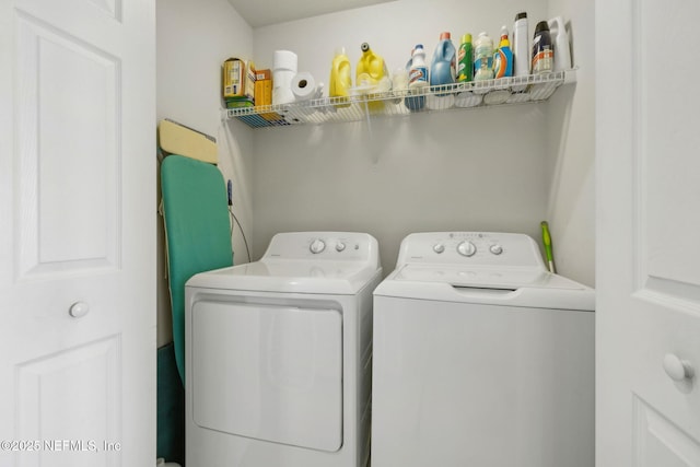 clothes washing area featuring washing machine and clothes dryer and laundry area