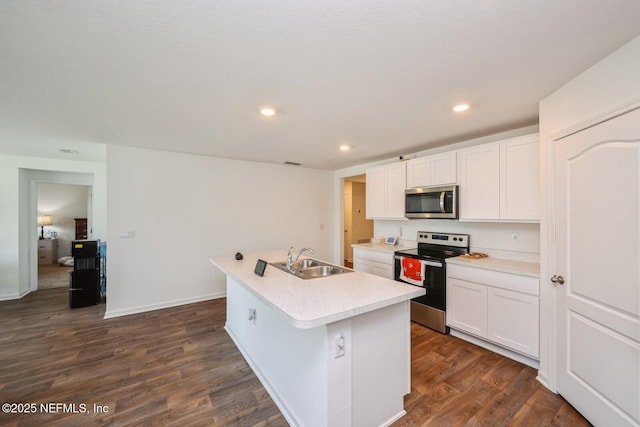 3044 Rustic Deer Way, Green Cove Springs, FL 32043 - kitchen with white cabinets, dark wood-style floors, stainless steel appliances, a sink, and a kitchen island with sink