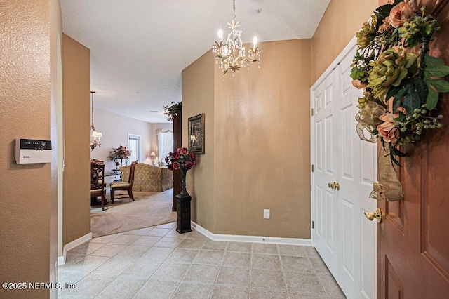 7801 Point Meadows Dr Unit 3209, Jacksonville, FL 32256 - entryway featuring light tile patterned flooring, light colored carpet, a notable chandelier, and baseboards