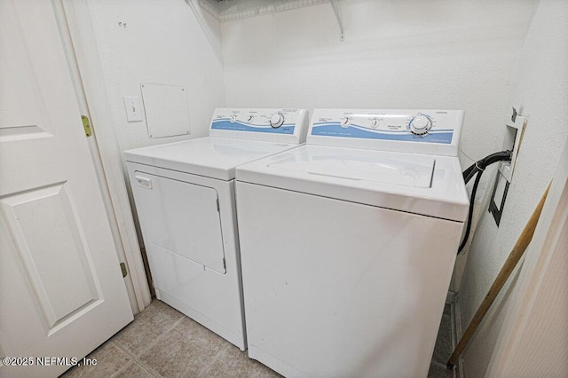7801 Point Meadows Dr Unit 3209, Jacksonville, FL 32256 - clothes washing area with light tile patterned floors, separate washer and dryer, and laundry area