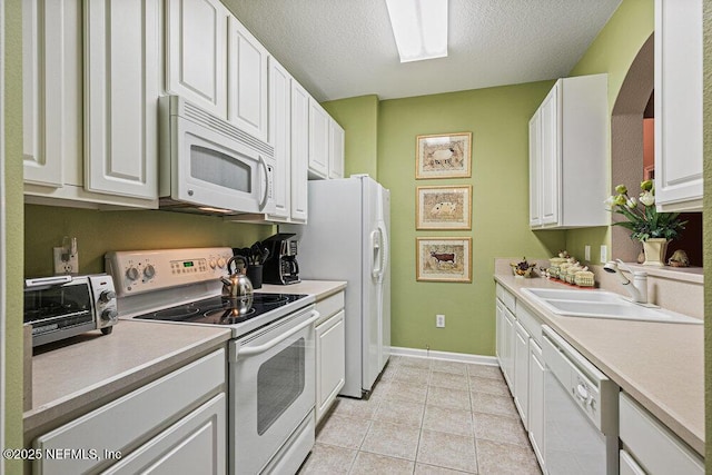 7801 Point Meadows Dr Unit 3209, Jacksonville, FL 32256 - kitchen featuring white appliances, light countertops, white cabinets, and a sink