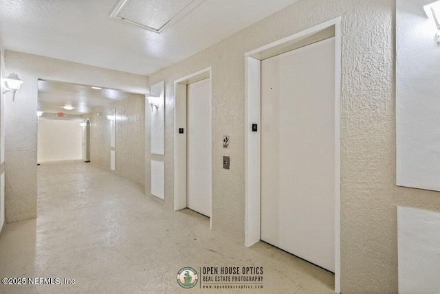 7801 Point Meadows Dr Unit 3209, Jacksonville, FL 32256 - hallway featuring elevator, concrete floors, and a textured wall
