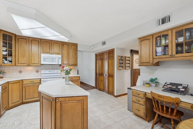 kitchen featuring white appliances, light countertops, and visible vents