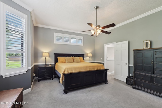 bedroom featuring light colored carpet, a textured ceiling, baseboards, and ornamental molding