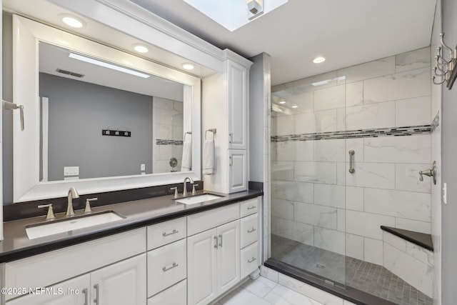 full bathroom featuring recessed lighting, marble finish floor, a stall shower, and a sink