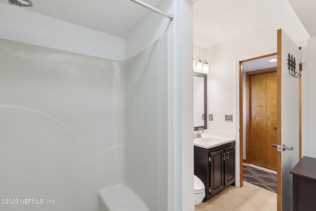full bathroom featuring toilet, tile patterned flooring, and vanity