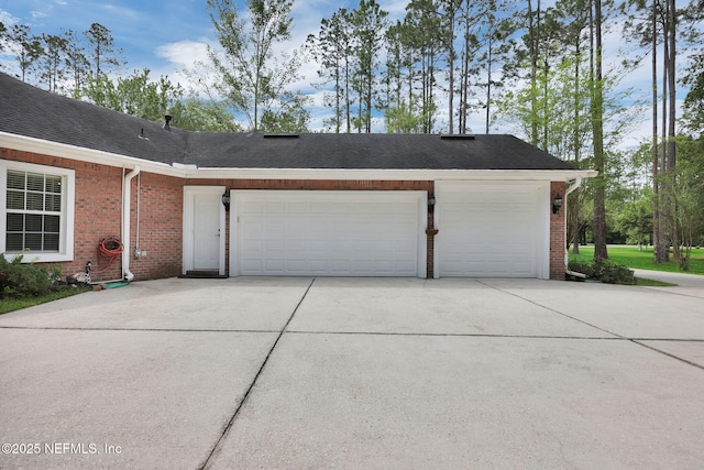 garage featuring concrete driveway