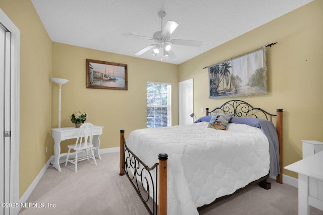 carpeted bedroom with baseboards and a ceiling fan