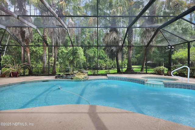 view of pool with glass enclosure and a pool with connected hot tub