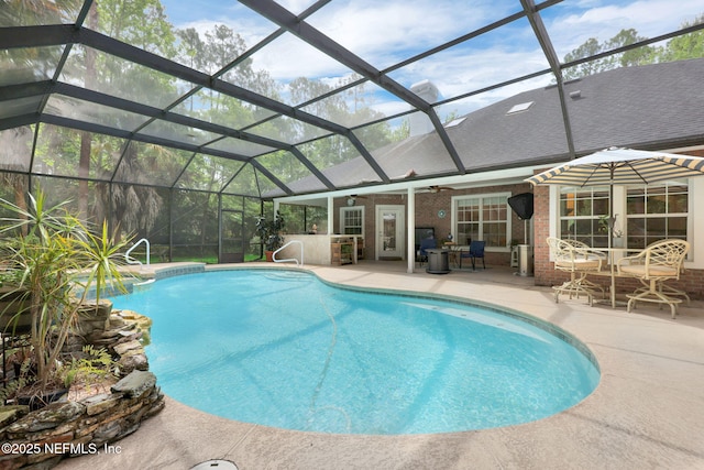 outdoor pool featuring ceiling fan, a patio area, and a lanai