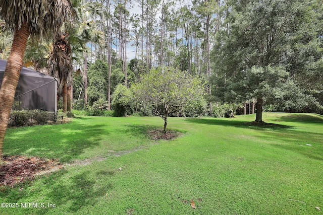 view of yard featuring a lanai